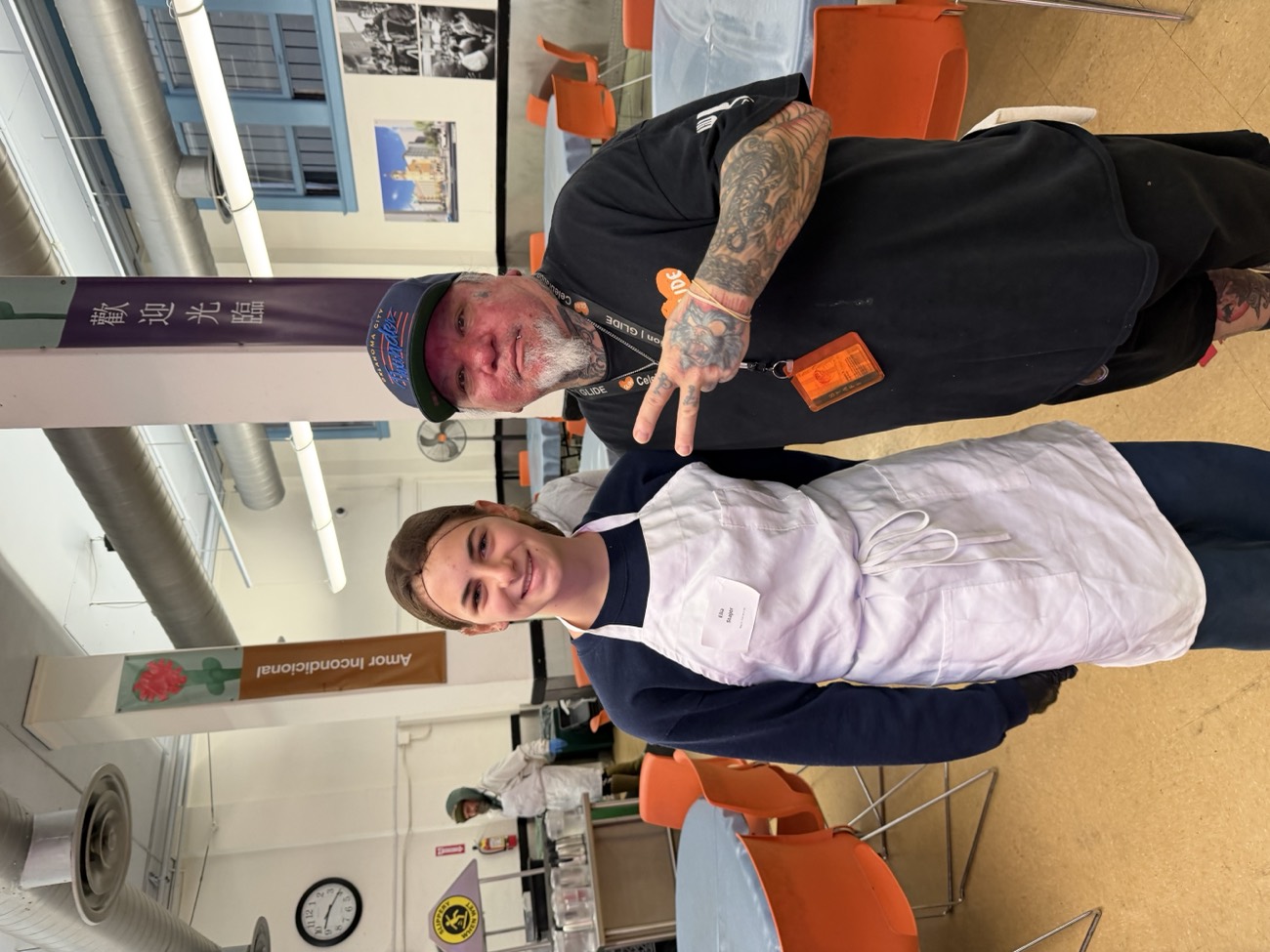Elia with a GLIDE guest in the dining hall